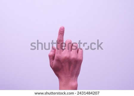 A photo of a hand with its index finger raised. Visualize pointing, one point, tap, first, and direction.