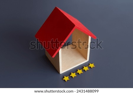 Toy house and five stars rating. Copy space for text. Real estate and property concept.