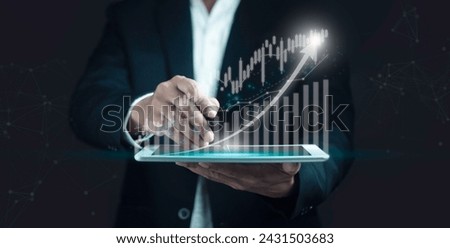 Businessman using tablet to analyze business growth.