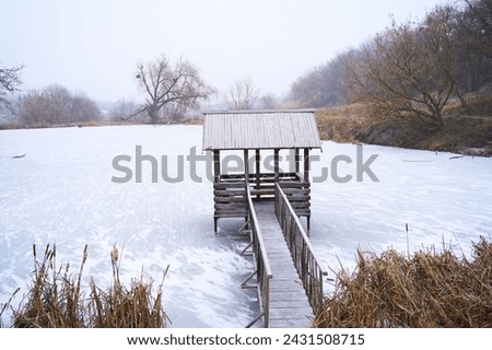 A gazebo on a winter lake. 