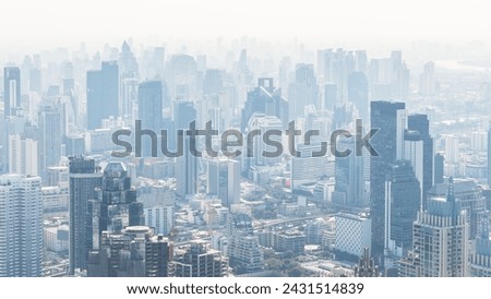 An aerial view showing the city in Bangkok, Thailand in the morning. There is thick PM 2.5 dust covering the entire city. This is a picture that shows the problem of the changing environment.