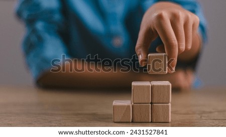 Blank wooden cubes on the table with copy space, empty wooden cubes for input wording, and an infographic icon..	

