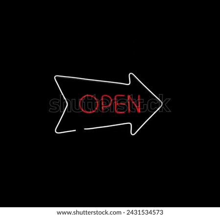 Retro neon sign with the word open. Vintage electric arrow symbol. Burning a pointer to a black wall in a club, bar or cafe. Design element for your ad, signs, posters, banners. Vector illustration.