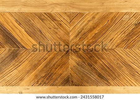 Chevron pattern on a wooden Acacia table top. Flatlay background for products and more.