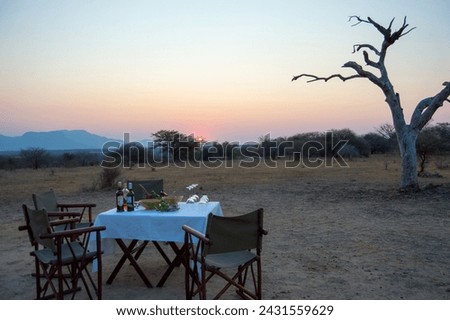 Sundowners in the Arican bush in  Hazyview Mpumalanga South Africa surrounded by mountains in the bush watching the sunset overlooking the African Mountains