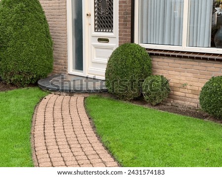 Garden path way and trimmed boxwoods. Beautiful green lawn Royalty-Free Stock Photo #2431574183