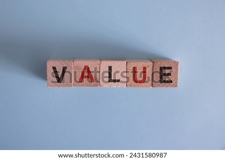Value symbol. Concept word value on wooden cubes. Businessman hand. Beautiful grey background with succulent plant. Business and value concept. Copy space. Concept word.