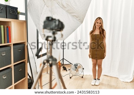 Young caucasian woman model having photo shooting photo studio