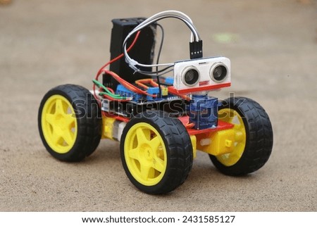 Programmable robotic car built using micro controller and ultrasonic distance sensor along with servos and dc motor. Working prototype of a car Royalty-Free Stock Photo #2431585127