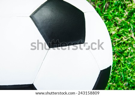 Close up of Soccer Football on Grass Field (in Stadium or Local Field)  Sport Concept and Idea  / for background, wallpaper, texture. Standard Ball Black and White.
