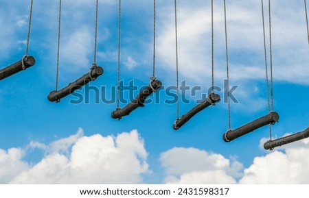 rope ladder against a blue sky and clouds Royalty-Free Stock Photo #2431598317