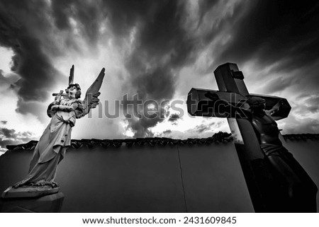 Statues of angel and christ on the cross in the cemetery of Alhambra