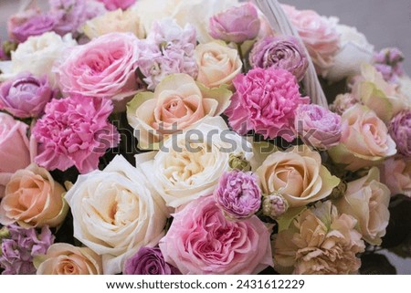 Flower arrangement in a basket.Bouquet of roses.flower shop.floristry training.floristry courses.pink roses in a basket. Royalty-Free Stock Photo #2431612229