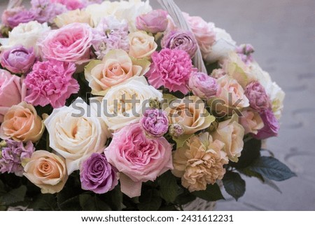 Flower arrangement in a basket.Bouquet of roses.flower shop.floristry training.floristry courses.pink roses in a basket. Royalty-Free Stock Photo #2431612231