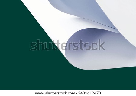 Sheets of white paper on a green background.