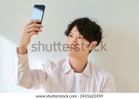 Young man looking at smartphone screen