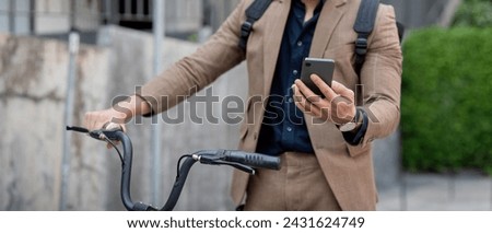 Businessman with bicycle using smartphone. man commuting on bike go to work. Eco friendly vehicle, sustainable lifestyle concept