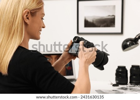 Professional photographer with digital camera indoors, closeup