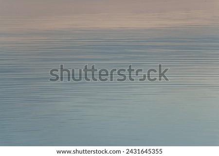 calm water surface in pastel colors at sunset, calming photo
