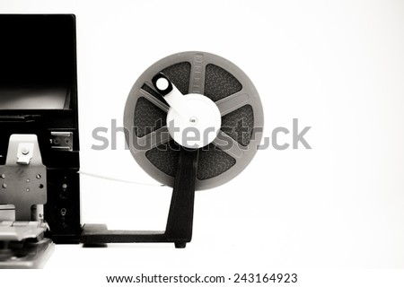 A vintage 8mm movie editing desktop in black and white with editing machine and reel on white background