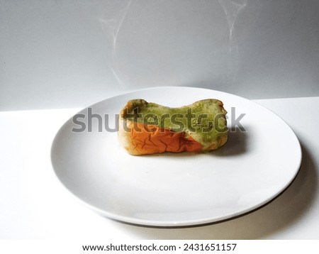 close-up of cheese bread with matcha lava on a white plate isolated on a white background