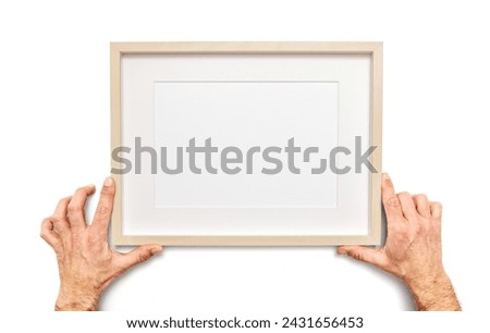 Male hands holds an empty picture frame on white background, including clipping path