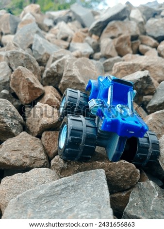 Toy offroad blue car in the rock
