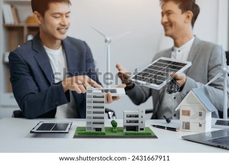 Asian business people using tablet for working technology and business, Renewable energy-based green businesses and global warming. Reduce CO2 emission.