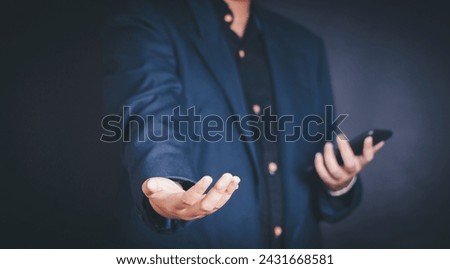 Businessman shaking hands, gesturing success with fingers