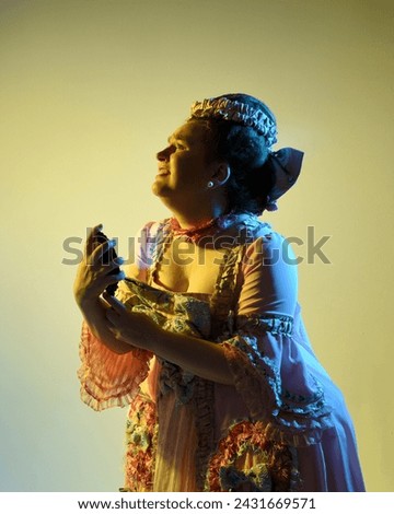  cinematic portrait of female model wearing an opulent pink gown,  costume of a historical French baroque nobility, style of Marie Antoinette. Holding hand mirror, Isolated on studio background. 