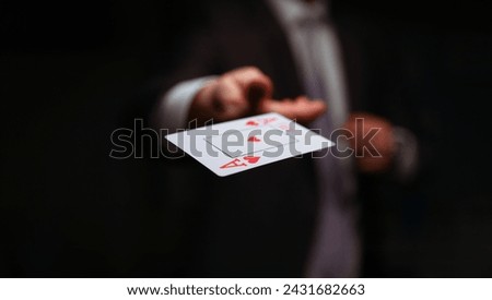 Close-up of male throwing trump out of sleeve. Professional player in presentable suit. Addiction gamers and risk. Strategy and business card game concept Royalty-Free Stock Photo #2431682663
