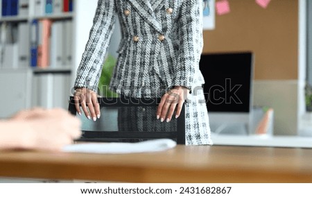 Close-up of businesswoman with nice manicure. Lady touching chair. Office worker in modern cabinet. Young woman in luxury suit. Business and presentable look concept Royalty-Free Stock Photo #2431682867