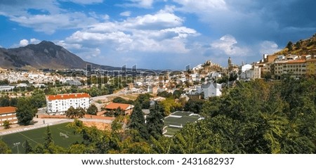 Panoramic view of Loja from the west, Sylvania viewpoint. View of the houses and their churches embedded in the valley of the Genil River. Town surrounded by crop fields and mountains. Loja, Spain.