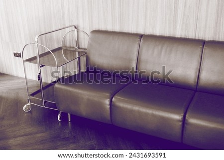 Red leather sofa and Vintage TV  in living room at hotel or restaurant,Cozy wooden interior of restaurant,copy space, Comfortable modern dining place, contemporary design background.