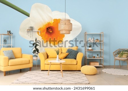 Stylish interior of room with yellow sofas and beautiful narcissus flower on wall