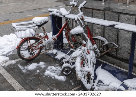 Bicycle covered with snow in winter. Bike covered with fresh snow. Bicycle in the snow