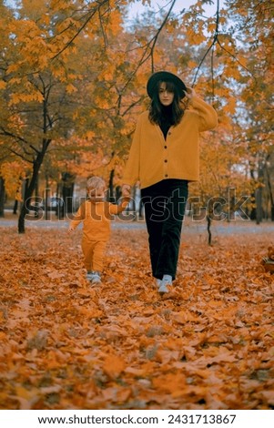 Mother and son enjoying a heartwarming walk in an autumn park. A perfect picture of family love and joy during a weekend outing.