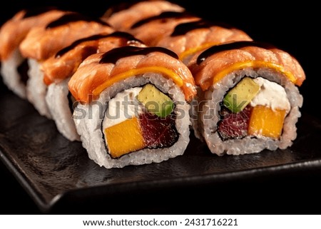 Photos of sushi, rolls, Japanese cuisine, isolated on a black background with kitchen utensils
