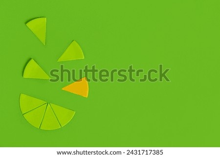 Composition with segments of paper circle on green background. Concept of uniqueness