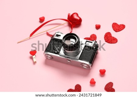 Composition with vintage photo camera and decor for Valentine's Day celebration on color background