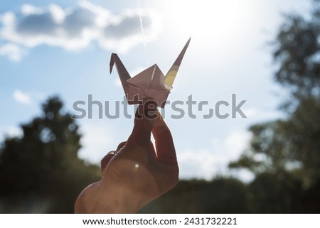 hand holding a paper origami