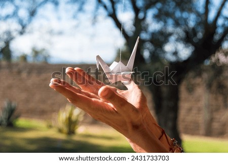  hands with a paper origami Royalty-Free Stock Photo #2431733703
