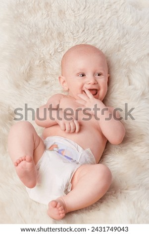 Happy baby, diaper and laugh in bedroom, furry blanket and playtime in cute for child development. Infant, kid and wellness for playing, adorable and positive on rug in house for home and toddler fun Royalty-Free Stock Photo #2431749043