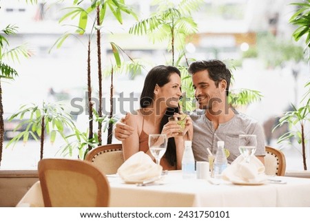 Couple, restaurant and drinks with lunch, love and romance for anniversary or celebration. Woman, man and date with luxury, fine dining and smile for relationship on holiday or vacation with meal Royalty-Free Stock Photo #2431750101