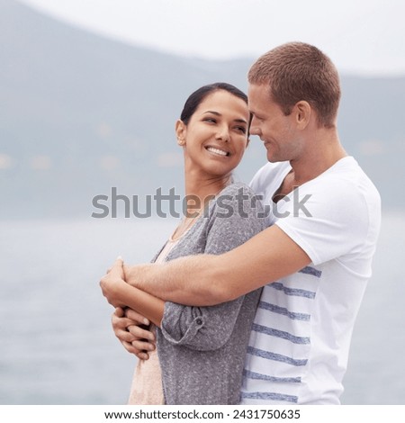 Couple, hug on beach and smile for travel, fresh air with ocean and happiness together outdoor. Romantic adventure, love and affection for bonding, support and trust with commitment on holiday Royalty-Free Stock Photo #2431750635