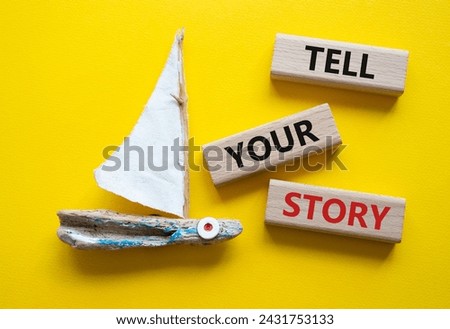 Tell your story symbol. Wooden blocks with words Tell your story. Beautiful yellow background with boat. Business and Tell your story concept. Copy space.