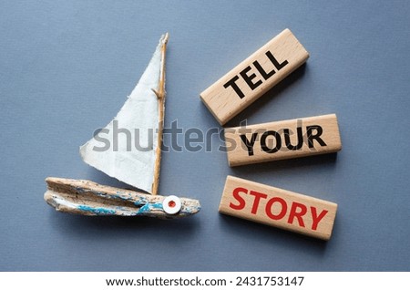 Tell your story symbol. Wooden blocks with words Tell your story. Beautiful grey background with boat. Business and Tell your story concept. Copy space.