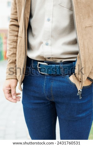 Men's blue leather belt for trousers. Blue belt on men's trousers