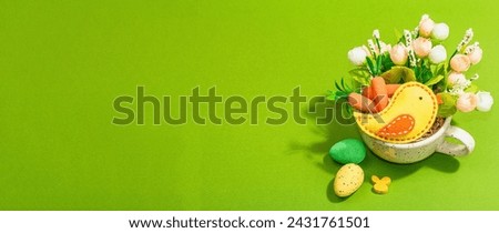 Easter bouquet in a cup. Traditional flowers, bird, decorative quail eggs. Trendy hard light, dark shadow, bright green background, place for text