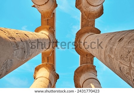 Different hieroglyphs on the walls and columns in the Karnak temple. Columns and blue sky in the great hypostyle hall at the Luxor temple, Egypt Royalty-Free Stock Photo #2431770423